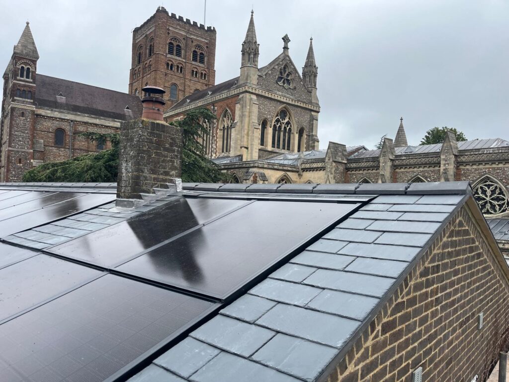 Finished Canadian slate and integrated solar roof with St Albans Cathedral behind